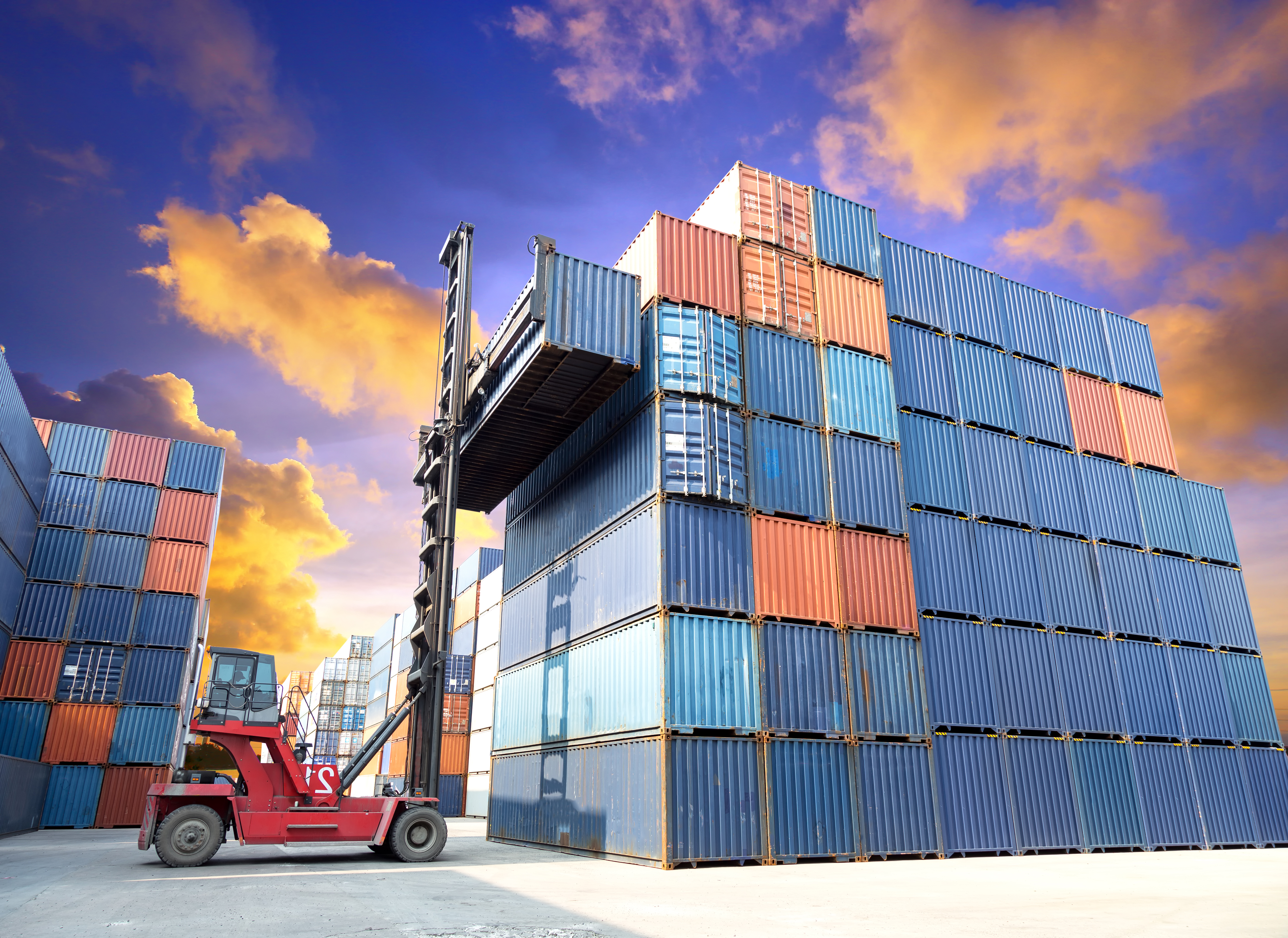 vorkheftruck die de containerdoos hanteert op de scheepswerf met prachtige lucht